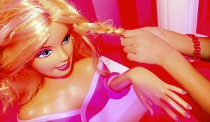 A young visitor braids the hair of a nearly lifesize Barbie at the Mall of America’s interactive Barbie Dreamhouse Experience, which opens Friday. 